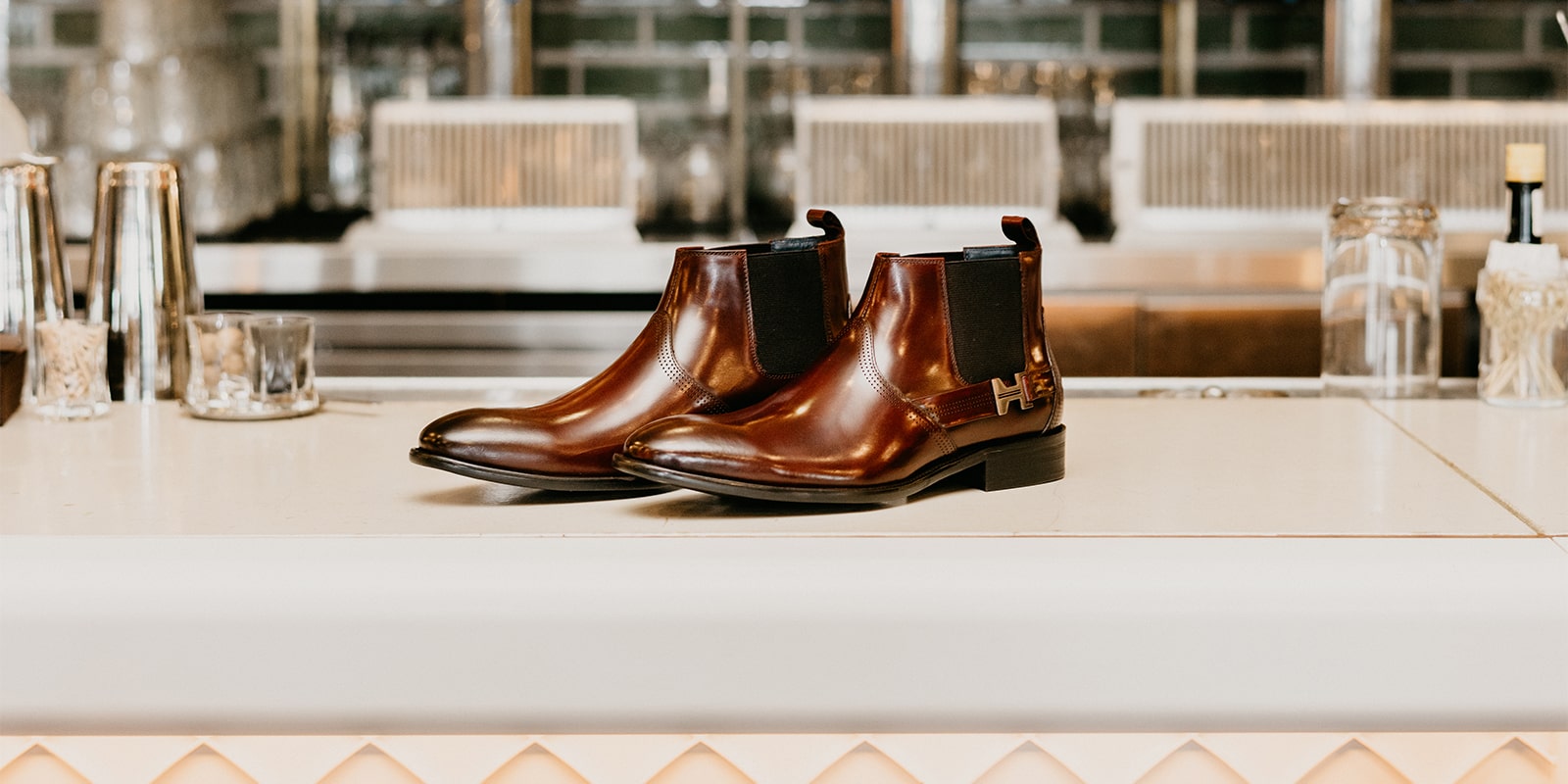 The featured product is the Joffrey Plain Toe Chelsea Boot in Cognac.